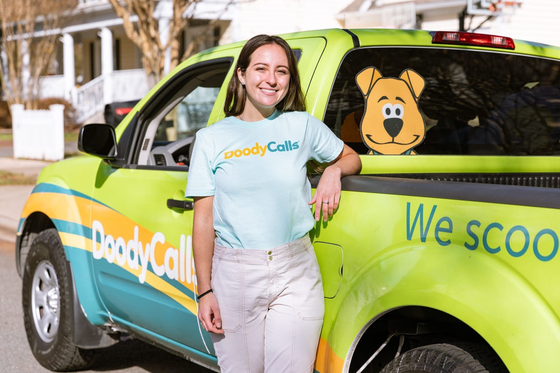 DoodyCalls franchise owner posing in front DoodyCalls truck